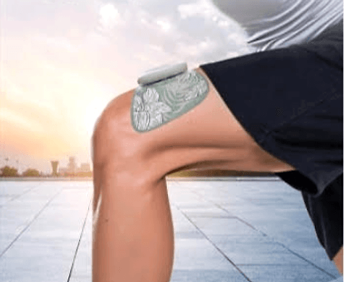 Wearable electrical stimulation pad in use on the leg during outdoor activity